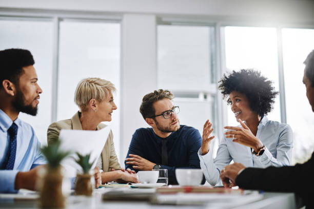 I need everyone to give me their best ideas Shot of a group of businesspeople sitting together in a meeting business diversity stock pictures, royalty-free photos & images