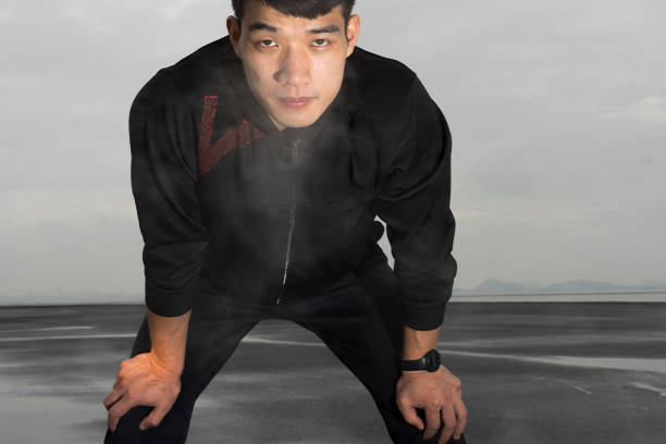 istock young asian athlete resting with sweat pouring after exercising 863498102