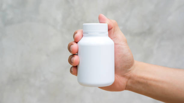 istock Man holding a white medicine bowl on gray background. 863498360