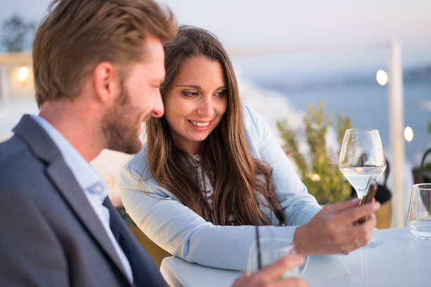 istock Authentic Wealth - couple at dining table with mobile phone 863505290