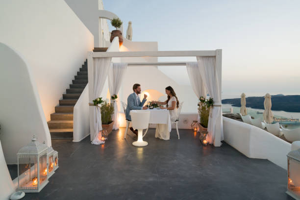 Authentic Wealth - dinner for two on private porch couple having candlelight dinner on romantic terrace with seaview honeymoon, vacation building terrace photos stock pictures, royalty-free photos & images