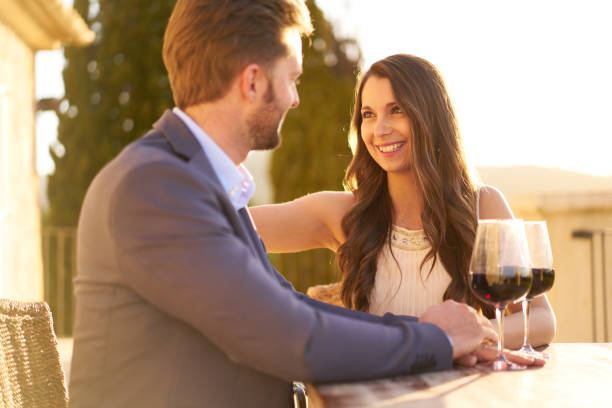 istock Authentic Wealth - rich couple enjoying red wine on porch 863505424