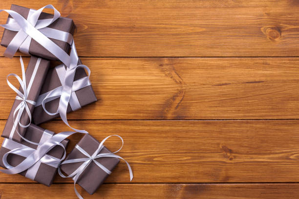 istock Presents in gift boxes on wood background with copy space 863511920