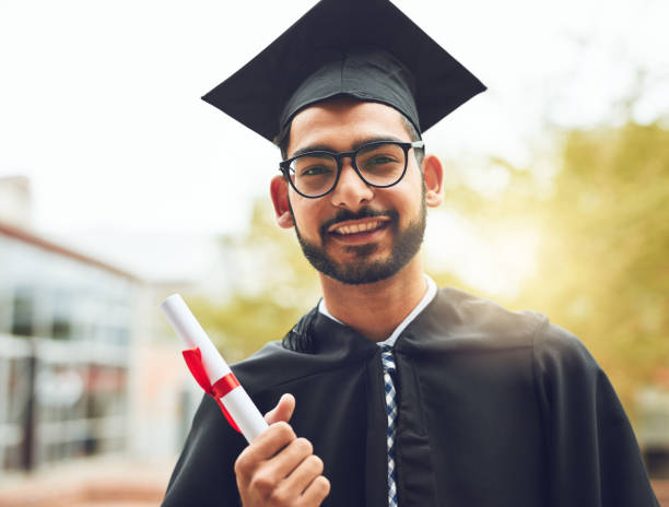 All it takes is perseverance Cropped shot of a happy graduate holding his diploma graduation man stock pictures, royalty-free photos & images