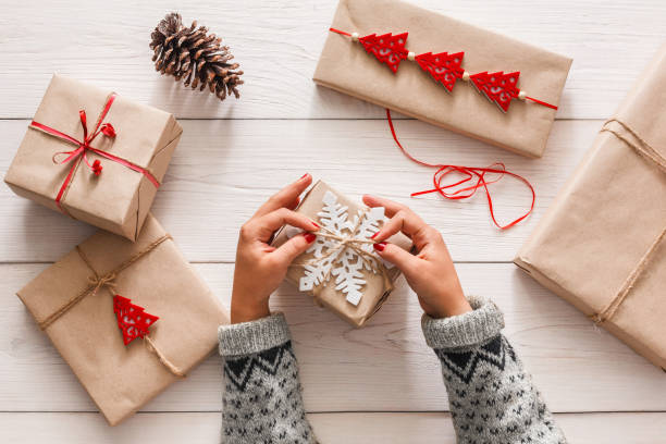 istock Woman's hands wrapping christmas holiday present with craft twine 863512730