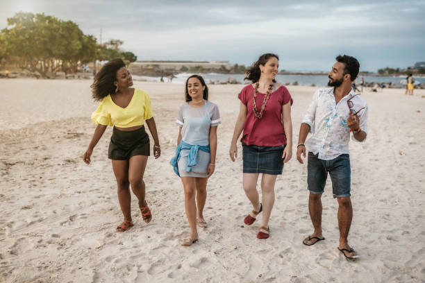 istock brazilian friends walking side by side at beach in Rio 863520024