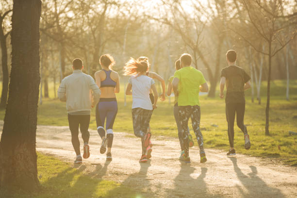 istock Rear view of joggers in park 863520524