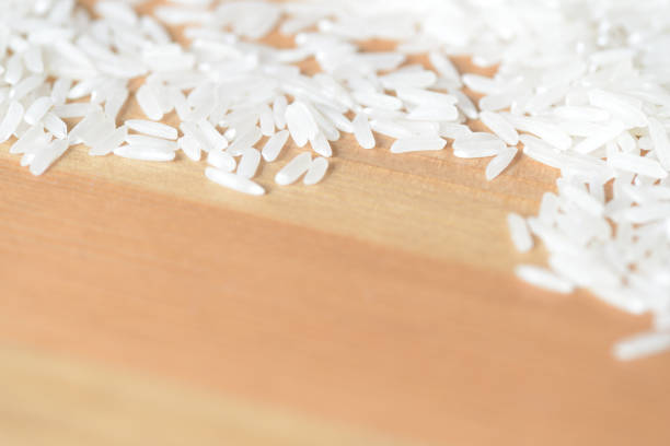 Scattered rice grains on the wooden surface