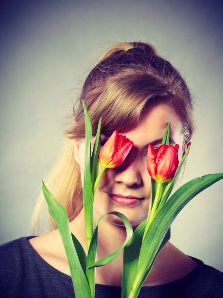 istock Blonde girl blinded by flowers. 863521372
