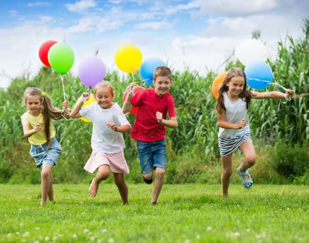 istock Children playing with colorful balloons 863521664