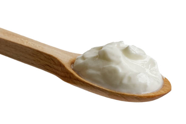 istock Skyr yoghurt on wooden spoon isolated on white. 863523074