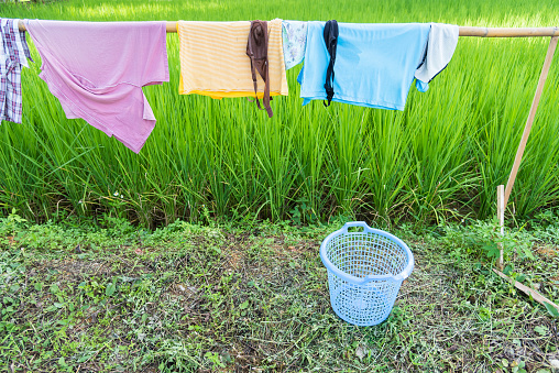 Wooden clothes line for dry clothes in the sun in paddy field.Thailand