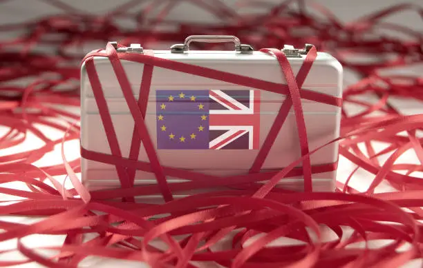 Red tape around a briefcase with european and british flags