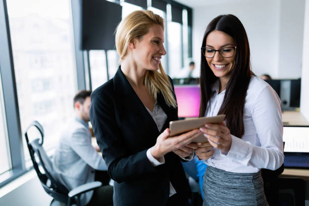 istock Attractive businesswomen using digital tablet in office 863524928
