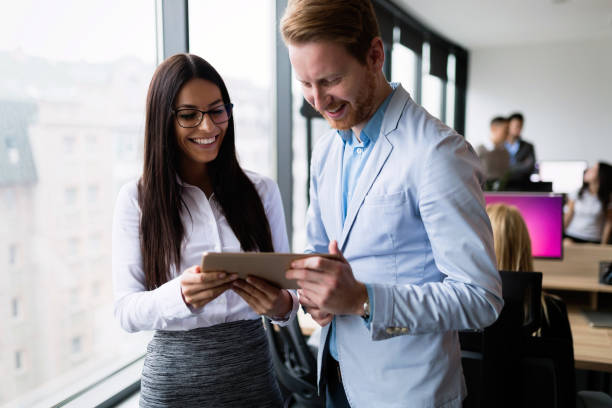istock Attractive business couple using tablet in their company 863525036