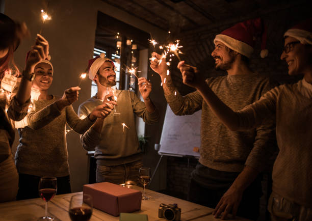 istock Group of happy people having fun while using sparklers on New Year's party. 863525072