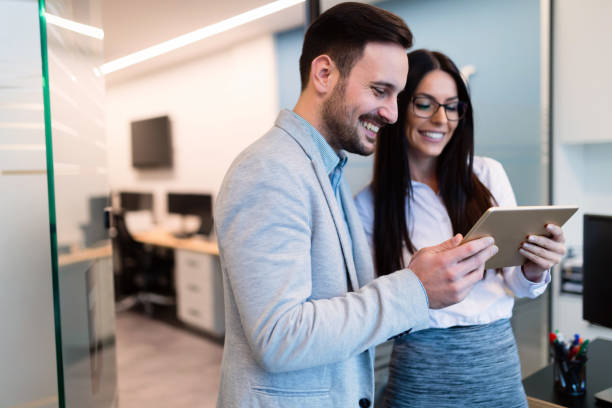 istock Attractive business couple using tablet in their company 863527768