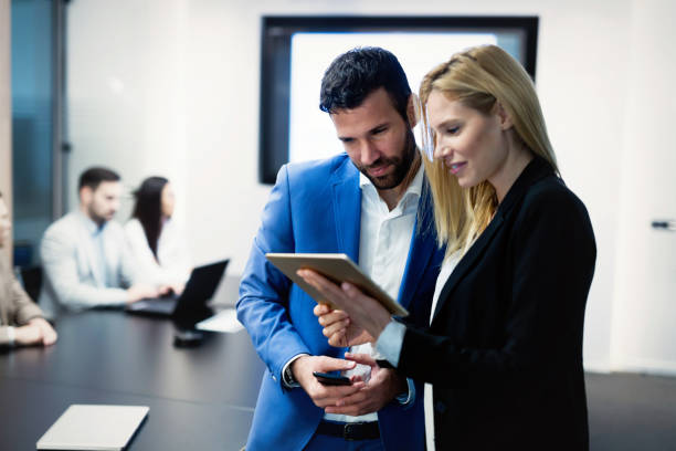 istock Attractive business couple using tablet in their company 863528688