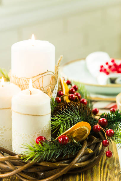 istock a table setting for Christmas with a viburnum on a plate and an ornament from a Christmas wreath with candles 863529278