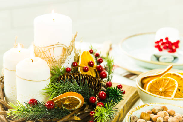 istock a table setting for Christmas with a viburnum on a plate and an ornament from a Christmas wreath with candles 863529328