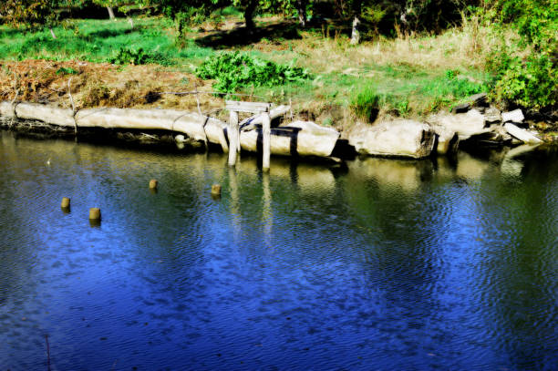 istock A tossed fishing rod by the river. 863537012