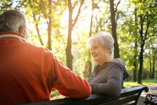 istock Senior couple sitting on bench after exercising and having conversation. 863541370
