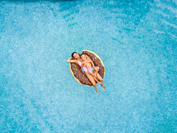 istock Mother and son relaxing at swimming pool 863549488