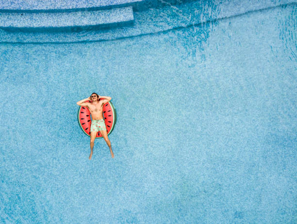 istock Man relaxing at swimming pool 863549494