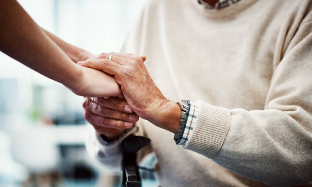 you're in my hands now - holding hands human hand senior adult consoling imagens e fotografias de stock