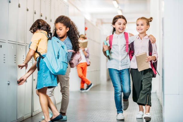istock schoolgirls walking through school corridor 863555540