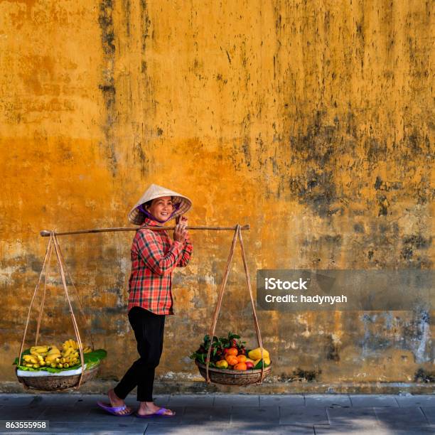 Vietnamese Woman Selling Tropical Fruits Old Town In Hoi An City Vietnam Stock Photo - Download Image Now