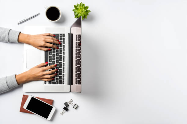 istock Female hands working on modern laptop. Office desktop on white background 863558910