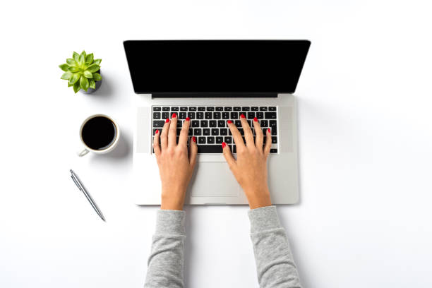 istock Female hands working on modern laptop. Office desktop on white background 863559298