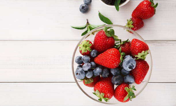 istock Mixed berries in glass bowls closeup, top view 863559468