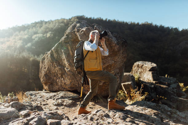istock Senior man taking photos of nature while hiking 863559818