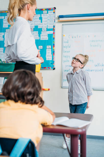 istock teacher talking to schoolgirl 863559994