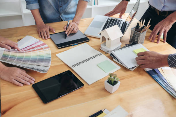 istock Young colleagues designers working together on a creative project and color samples for selection, Color swatch samples, Brainstorming Planning Partnership, creative graphic design working desktop 863564954