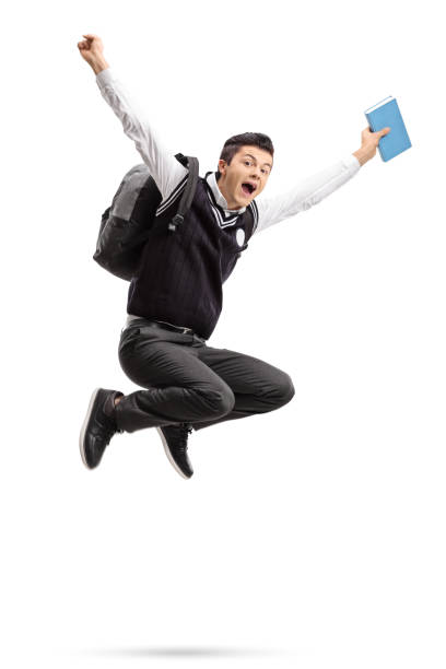 istock Overjoyed teenage student with a backpack and a book jumping 863565540