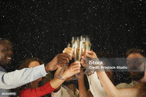 Group Of Young People Celebrating New Year With Champagne At Night Club Stock Photo - Download Image Now