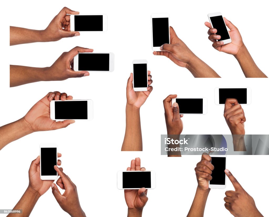 Male hands pointing, holding mobile phone Set of black male hand touching mobile phone display and pointing with index finger on black screen, white isolated background. Communication concept Human Hand Stock Photo