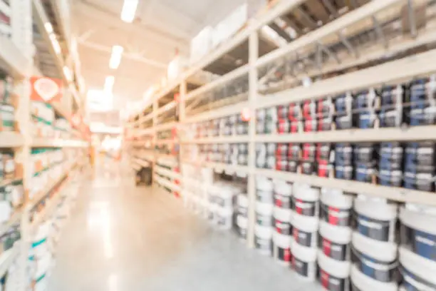 Photo of Blurred rack of paint cans in home improvement hardware store USA