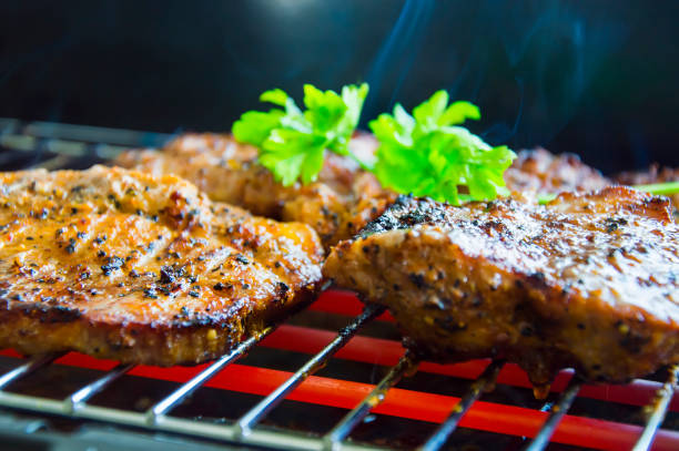 istock Pork steak with onion and parsley on electric grill 863572552