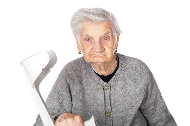 istock Disabled elderly woman with crutch 863572598