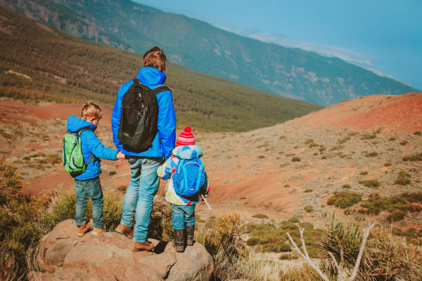 istock father and two kids hiking in mountains 863572828