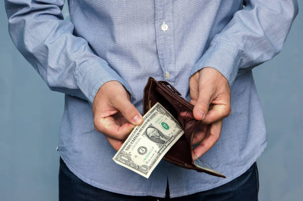 istock Man gets money from the wallet 863577654