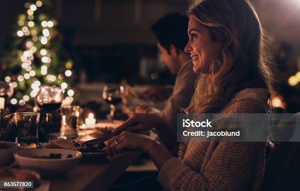 Beautiful Woman Having Christmas Dinner With Family Stock Photo - Download Image Now