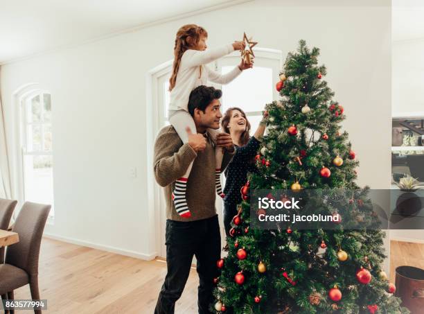 Foto de Família Celebrando O Natal Em Casa e mais fotos de stock de Natal -  Natal, Família, Árvore de Natal - iStock