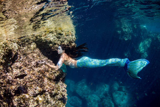 istock Mermaid swimming underwater in the deep blue sea 863578066