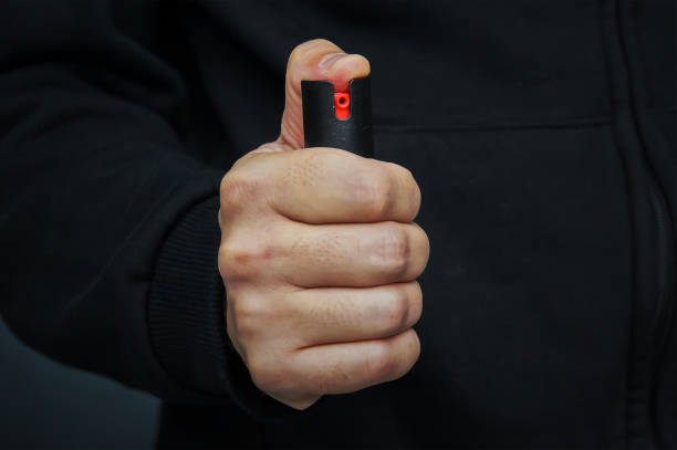 istock Hand with bottle of pepper spray. 863578240