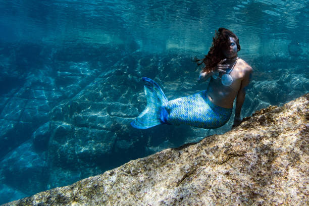 istock Mermaid swimming underwater in the deep blue sea 863578426